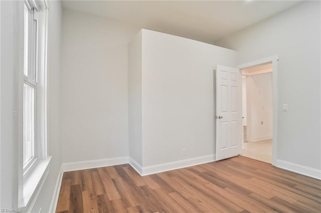 empty room with hardwood / wood-style floors