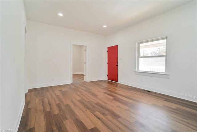 empty room with dark wood-type flooring