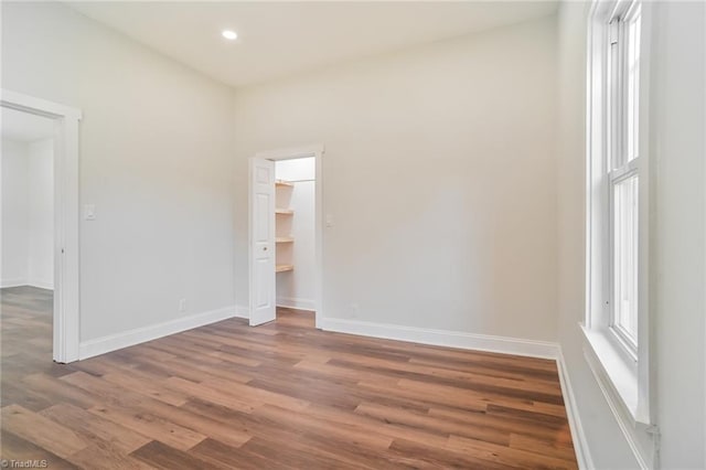 empty room with hardwood / wood-style flooring