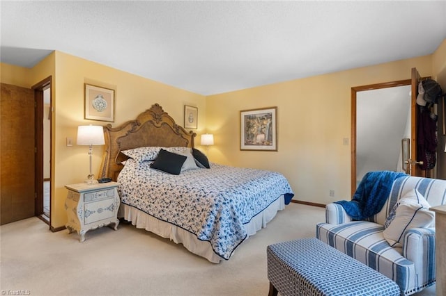 bedroom featuring light colored carpet and baseboards