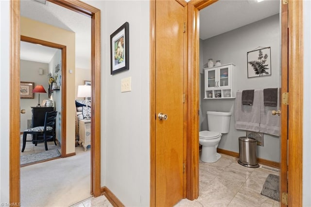 bathroom featuring toilet and baseboards