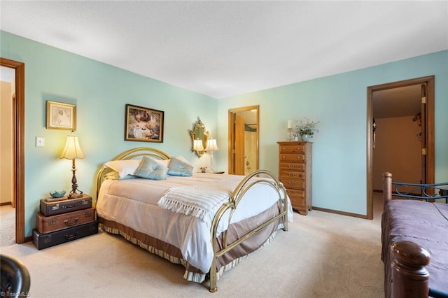 carpeted bedroom featuring baseboards