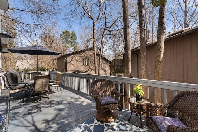 wooden deck featuring outdoor dining space