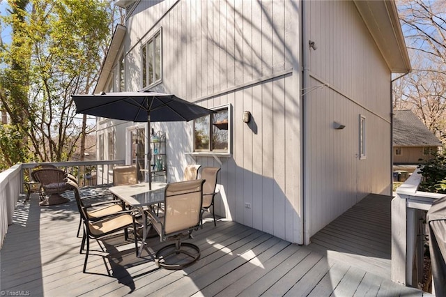 wooden deck featuring outdoor dining area