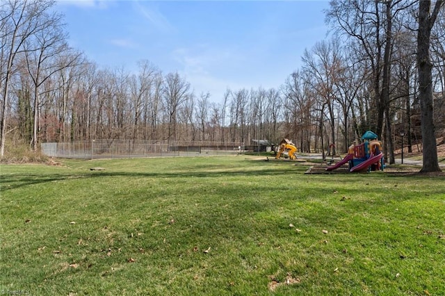 view of yard with playground community and fence