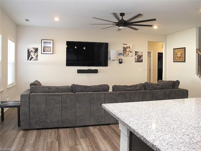 living room with hardwood / wood-style flooring and ceiling fan