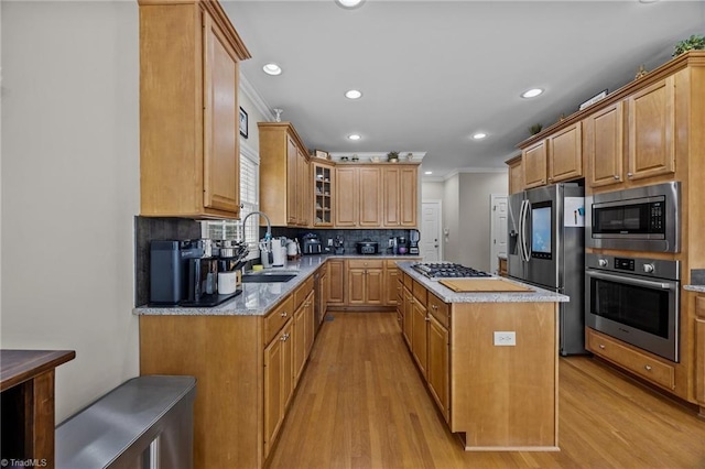 6089 Pleasant Field Dr, Greensboro, NC 27455 - kitchen with appliances with stainless steel finishes, a sink, light wood-style floors, crown molding, and a center island