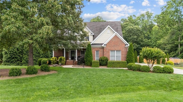 6089 Pleasant Field Dr, Greensboro, NC 27455 - view of front facade with a front lawn and brick siding