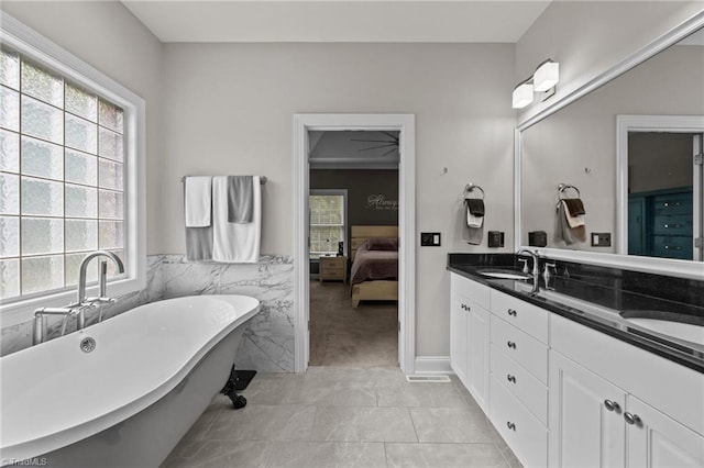 6089 Pleasant Field Dr, Greensboro, NC 27455 - ensuite bathroom featuring double vanity, a soaking tub, and tile patterned flooring