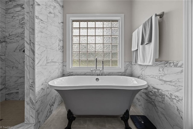 6089 Pleasant Field Dr, Greensboro, NC 27455 - bathroom featuring tile walls, a freestanding tub, and a wainscoted wall