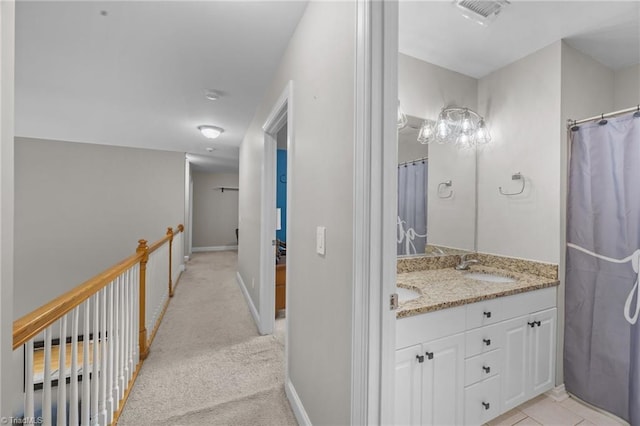 6089 Pleasant Field Dr, Greensboro, NC 27455 - full bathroom with double vanity, baseboards, and curtained shower