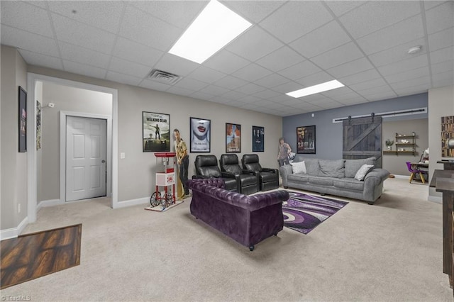 6089 Pleasant Field Dr, Greensboro, NC 27455 - living room with a barn door, carpet flooring, a drop ceiling, and baseboards