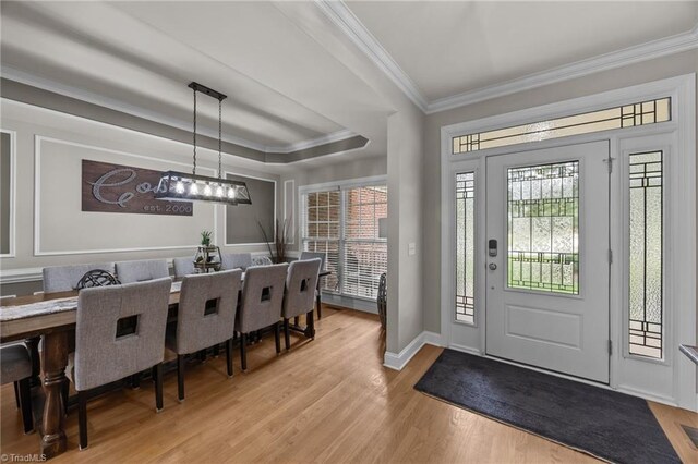 6089 Pleasant Field Dr, Greensboro, NC 27455 - foyer entrance featuring ornamental molding, light wood-type flooring, a raised ceiling, baseboards, and a chandelier