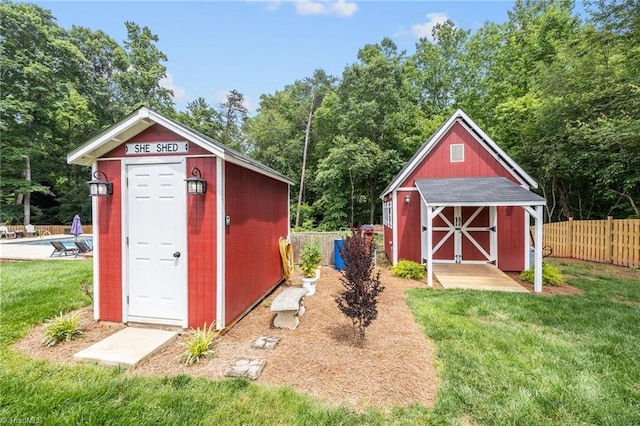 6089 Pleasant Field Dr, Greensboro, NC 27455 - view of shed with a pool and view of scattered trees