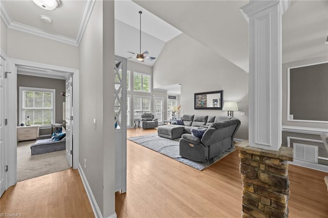 6089 Pleasant Field Dr, Greensboro, NC 27455 - living room with ornate columns, light wood-style flooring, ceiling fan, baseboards, and crown molding