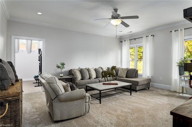 carpeted living room with ornamental molding and ceiling fan