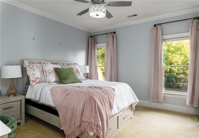 bedroom featuring ornamental molding, multiple windows, and ceiling fan