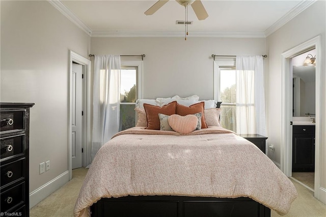 bedroom with ensuite bath, light carpet, multiple windows, and ceiling fan