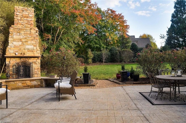 view of patio / terrace featuring an outdoor stone fireplace