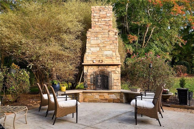 view of patio / terrace featuring an outdoor stone fireplace