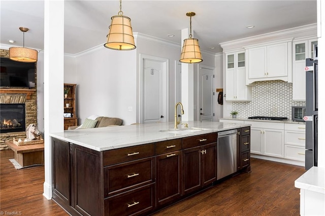 kitchen with sink, hanging light fixtures, stainless steel appliances, and dark hardwood / wood-style floors