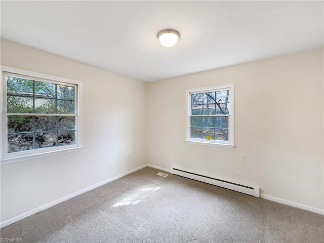 carpeted spare room with a wealth of natural light, baseboards, and baseboard heating