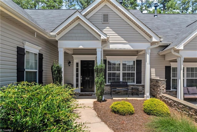 211 Hawks Nest Cir, Clemmons, NC 27012 - entrance to property with a porch, stone siding, and roof with shingles