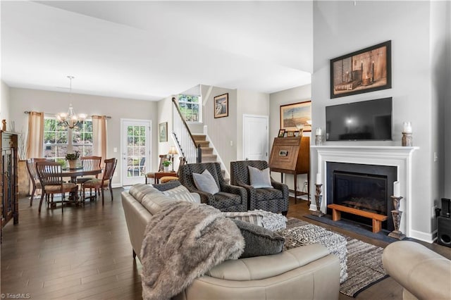 211 Hawks Nest Cir, Clemmons, NC 27012 - living room with a chandelier, dark wood-style flooring, stairs, and a fireplace with flush hearth
