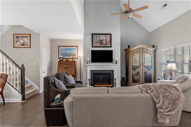 211 Hawks Nest Cir, Clemmons, NC 27012 - living area with ceiling fan, dark wood finished floors, stairs, a glass covered fireplace, and high vaulted ceiling