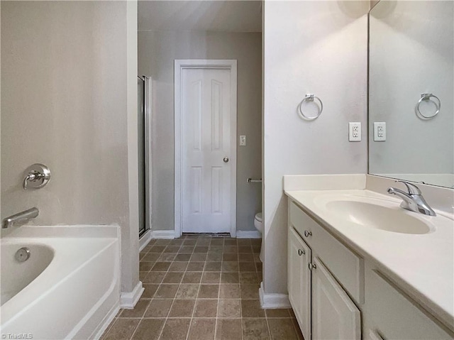 bathroom featuring toilet, a shower with shower door, vanity, baseboards, and a bath