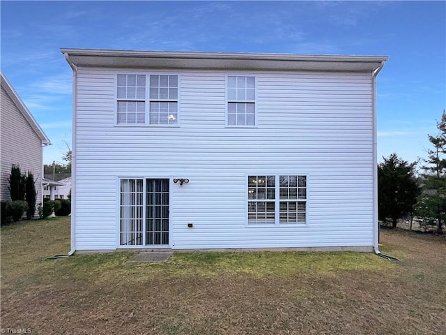 rear view of house with a lawn