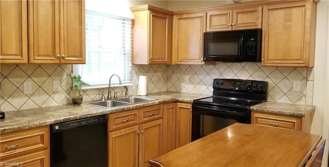 kitchen with black appliances, light stone counters, sink, and tasteful backsplash