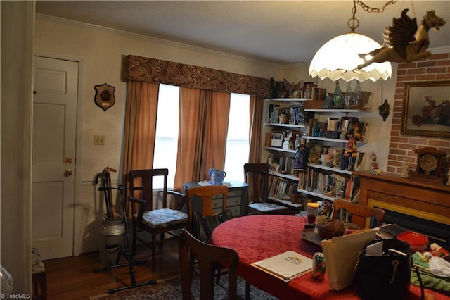 sitting room featuring ornamental molding and wood finished floors