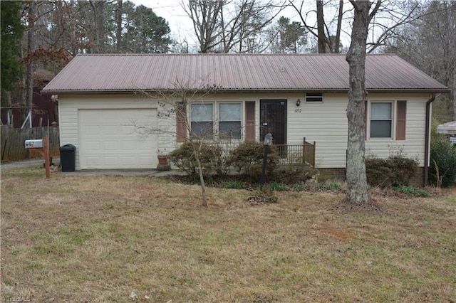 single story home featuring an attached garage, metal roof, and a front yard