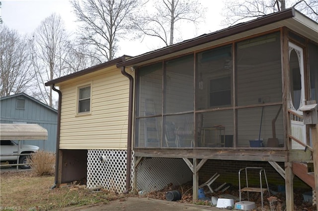 view of property exterior featuring a sunroom