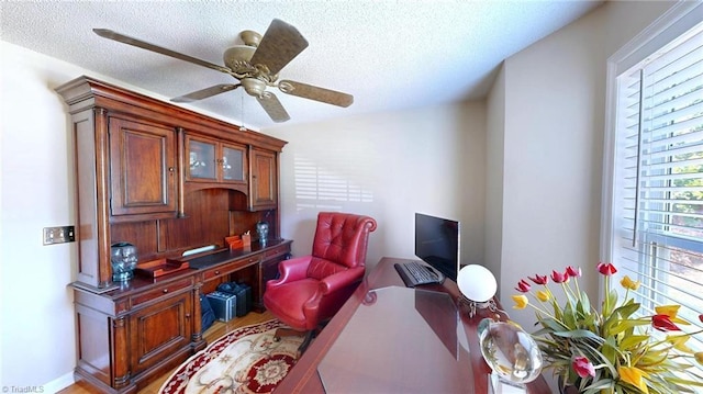 home office with a textured ceiling and a ceiling fan