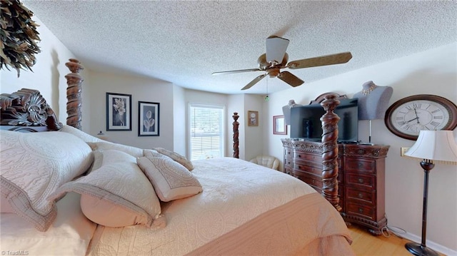 bedroom featuring a textured ceiling, wood finished floors, and ceiling fan
