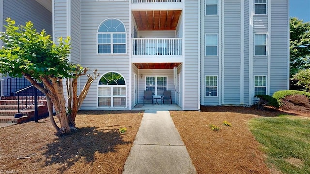 view of exterior entry featuring a patio area