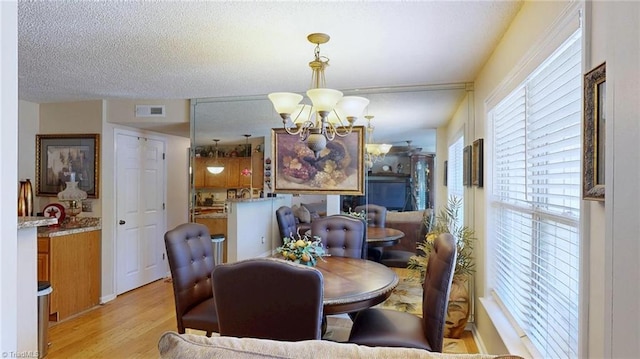 dining area featuring a chandelier and light wood-style floors