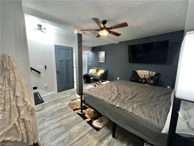 bedroom with ceiling fan and light wood-type flooring