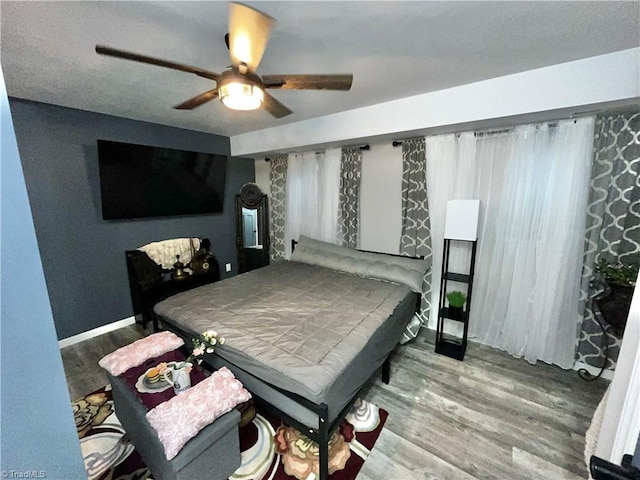 bedroom with hardwood / wood-style floors and ceiling fan