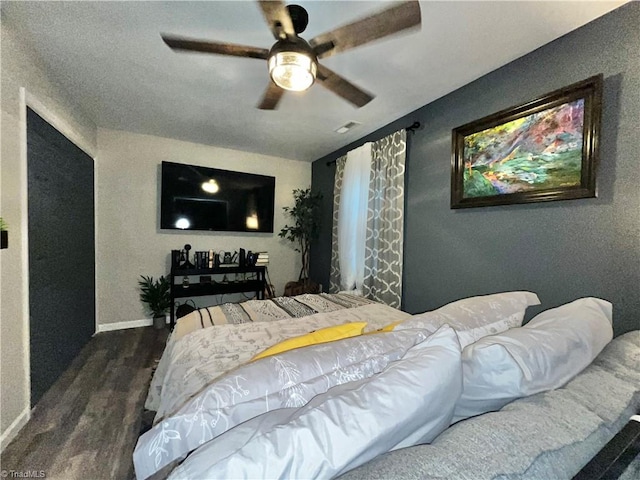 bedroom featuring ceiling fan and dark hardwood / wood-style floors