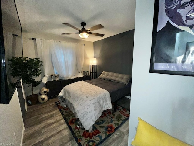 bedroom featuring hardwood / wood-style flooring and ceiling fan