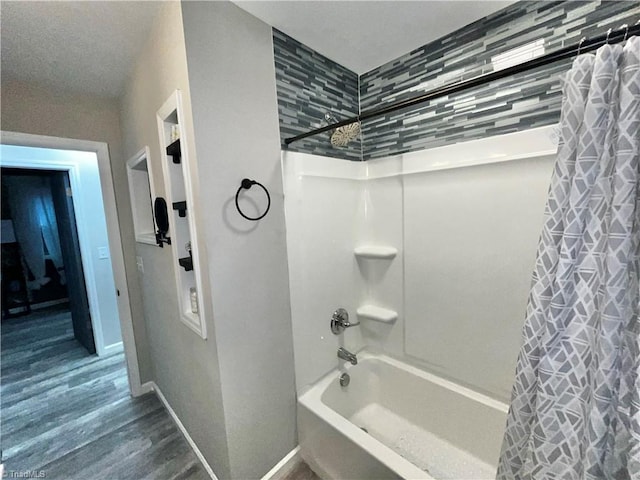 bathroom featuring hardwood / wood-style flooring and shower / tub combo with curtain