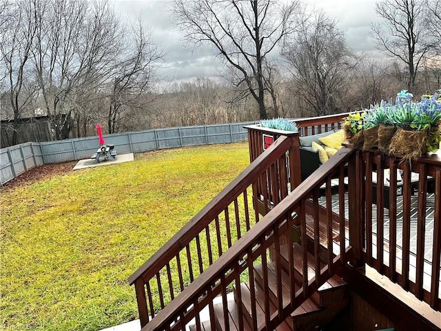 wooden deck featuring a lawn