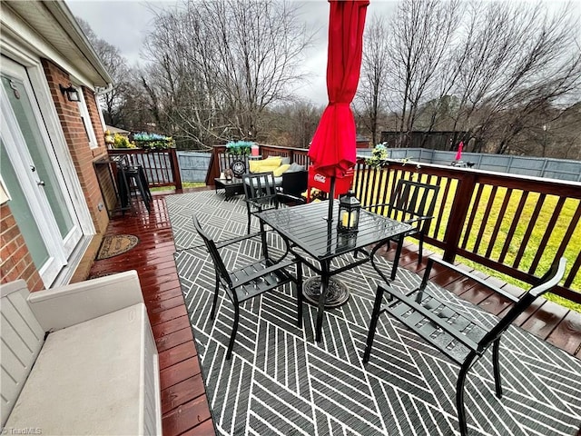 wooden deck featuring a lawn