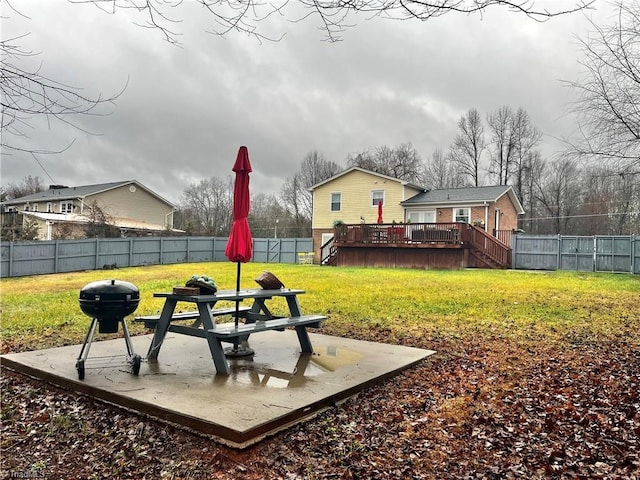 view of yard featuring a patio area and a deck