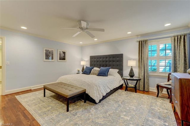 bedroom with ornamental molding, wood finished floors, baseboards, ceiling fan, and recessed lighting