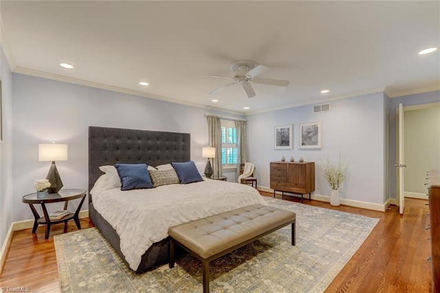 bedroom featuring crown molding, recessed lighting, baseboards, wood finished floors, and visible vents