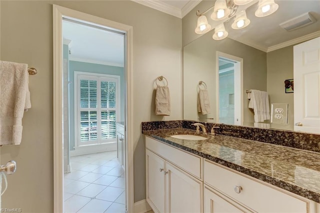 bathroom with vanity, ornamental molding, baseboards, and tile patterned flooring